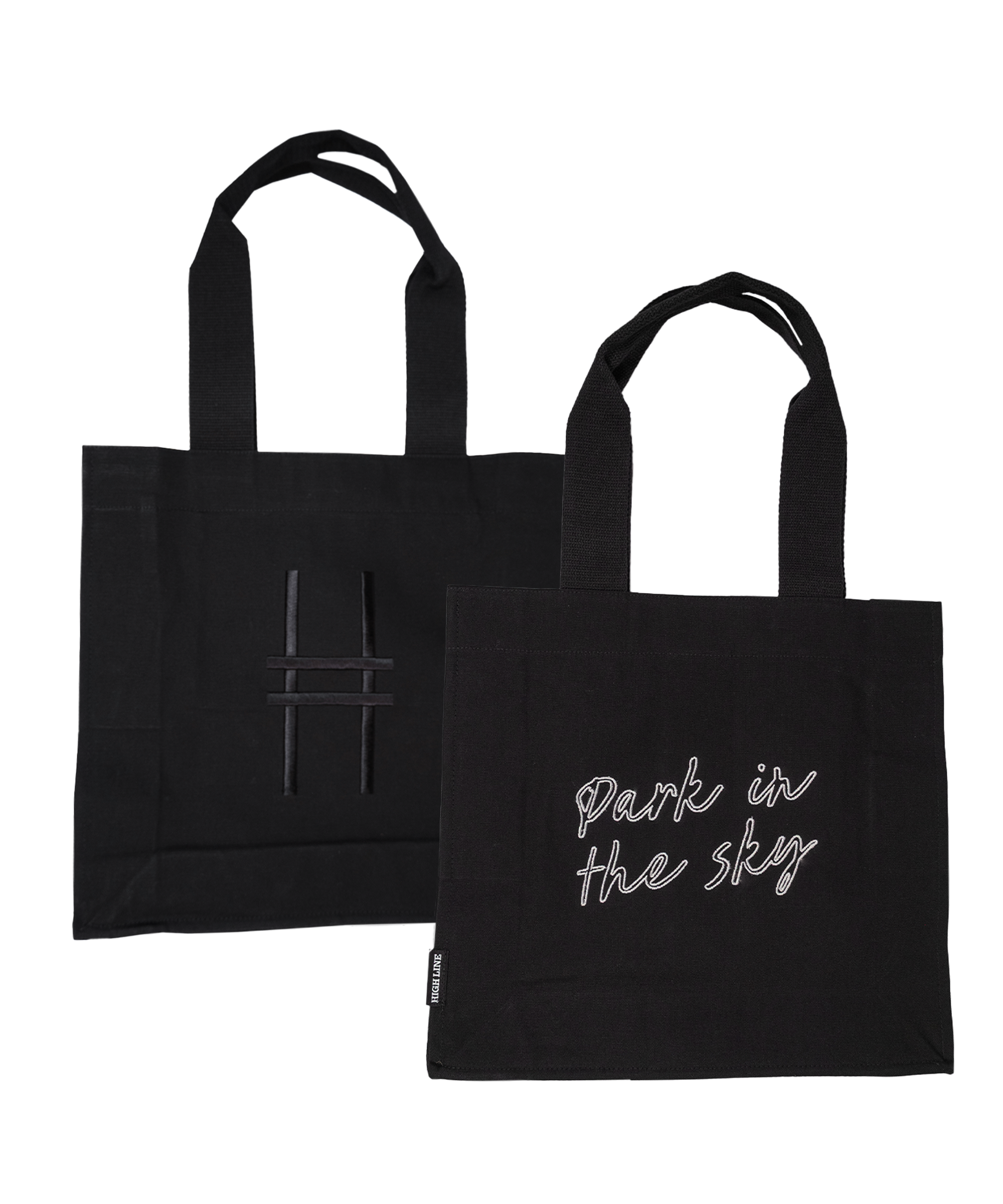 Both sides of the Park in the Sky Tote in Black—one side features the tagline "park in the sky" embroidered in white and the other the railroad track "H" icon embroidered in black against black canvas with black straps.