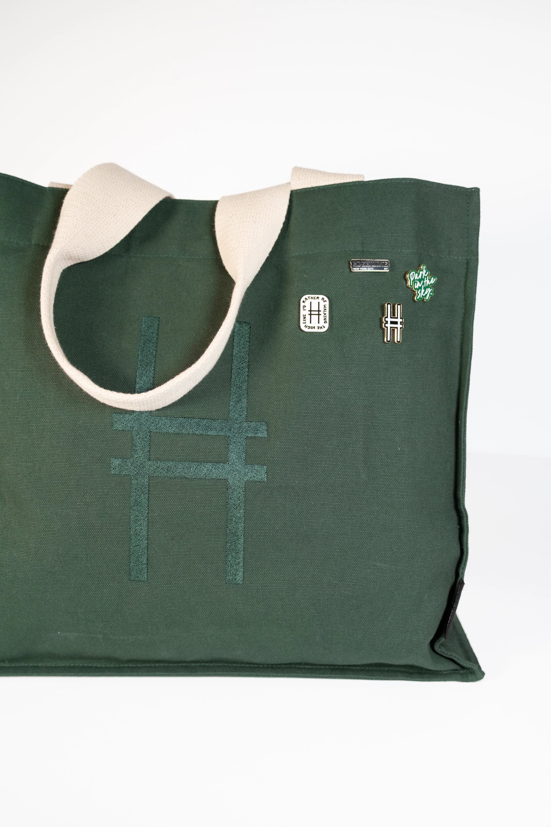 Park in the Sky Tote in Ivy featuring the High Line Icon collection enamel pins.