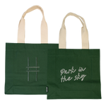 Both sides of the Park in the Sky Tote in Ivy—one side features the tagline "park in the sky" embroidered in white and the other the railroad track "H" icon embroidered in dark green against the dark Ivy green canvas with natural straps.