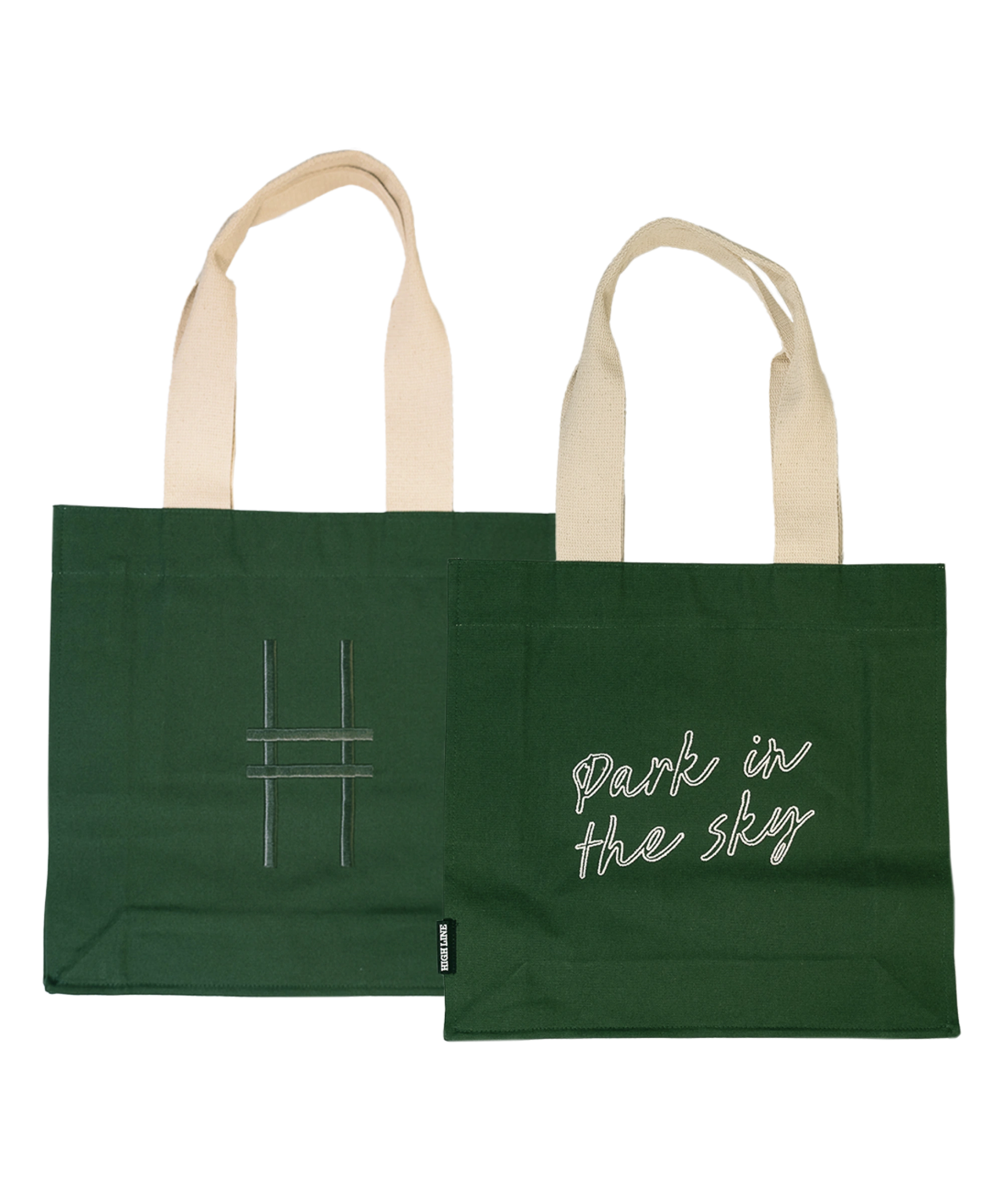 Both sides of the Park in the Sky Tote in Ivy—one side features the tagline "park in the sky" embroidered in white and the other the railroad track "H" icon embroidered in dark green against the dark Ivy green canvas with natural straps.