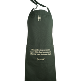 Piet Oudolf Quote Apron in dark green, featuring the High Line icon and the quote "The garden is a promise. And I think that promise is why you want to come back." in a pale yellow.