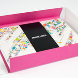 The open card box of the Piet Oudolf Notecard Set. The cards feature illustrated garden designs and are secured in a black band that reads "High Line"