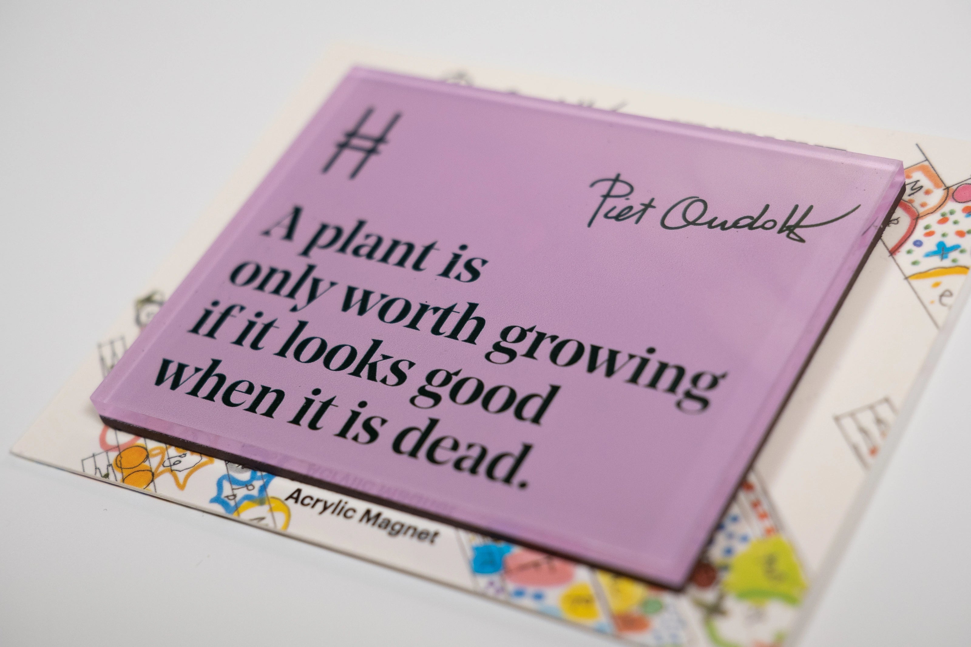 Acrylic fridge magnet featuring the quote "A plant is only worth growing if it looks good when it is dead." in dark green against a pale purple, with Piet Oudolf's signature and the High Line icon.
