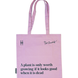Piet Oudolf Quote Tote in Aster—a pale purple cotton canvas tote bag featuring the quote "A plant is only worth growing if it looks good when it is dead." The quote, Oudolf's signature, and the High Line icon are all in a dark Ivy green.