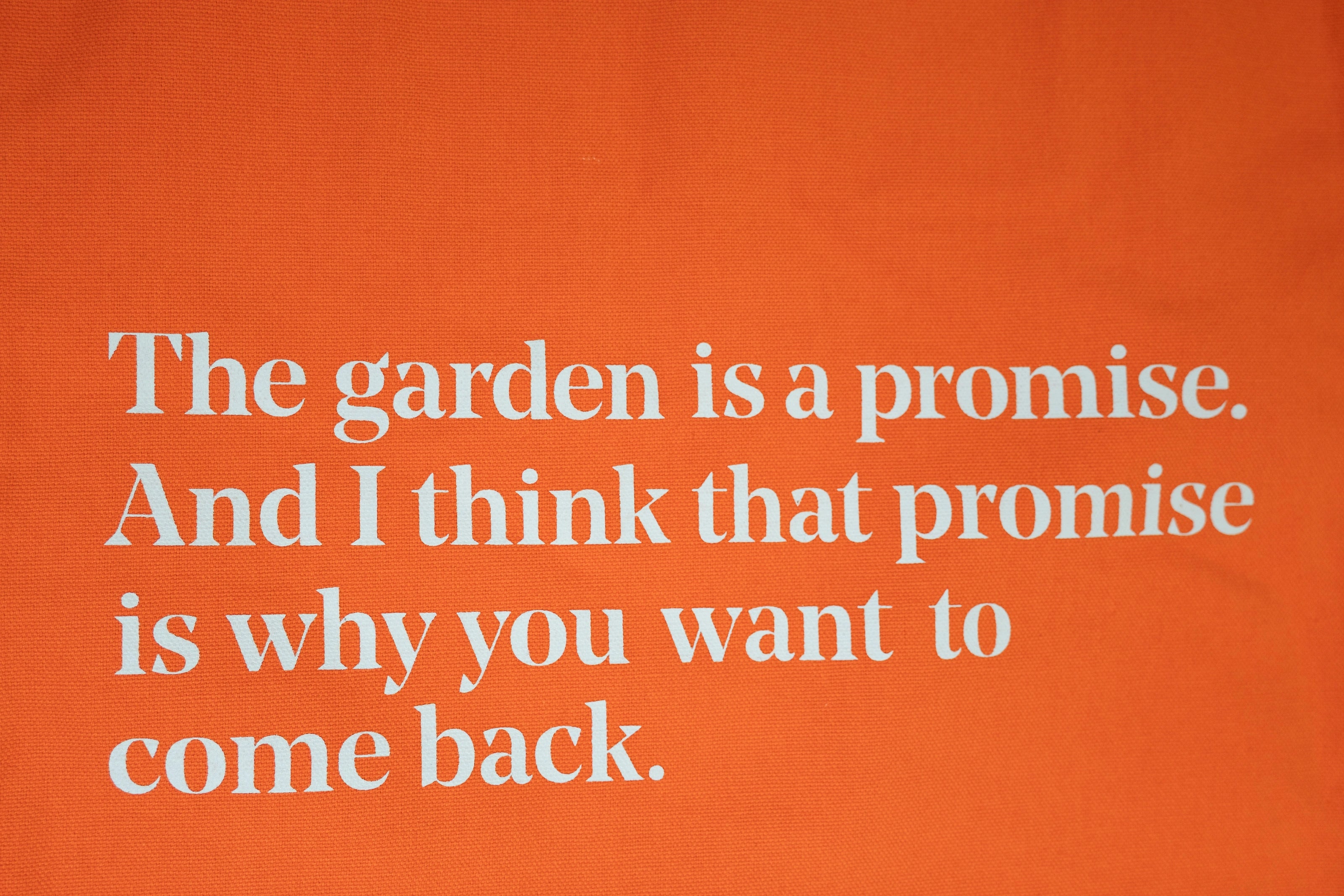 Closeup of the quote "The garden is a promise. And I think that promise is why you want to come back."