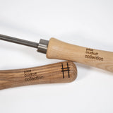 Sneeboer trowel and hand hoe with High Line icon and "Piet Oudolf collection" embossed on the wood handles—closeup of the handles.