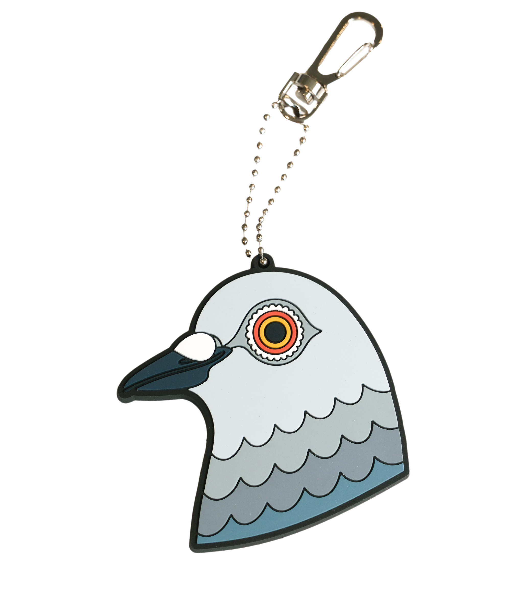 The Dinosaur head bag charm. A stylized PVC rubber bag charm shaped like a pigeon head. It is attached to a silver ball chain and a silver carabiner clip, shown on a plain white background.
