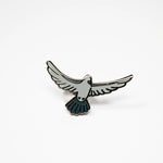 Pigeon in flight enamel pin.
