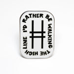 White enamel rectangular pin with rounded edges. At the center is the High Line icon, with the text "I'd rather be walking the High Line" wrapping around the border. Pin shown against a white background.