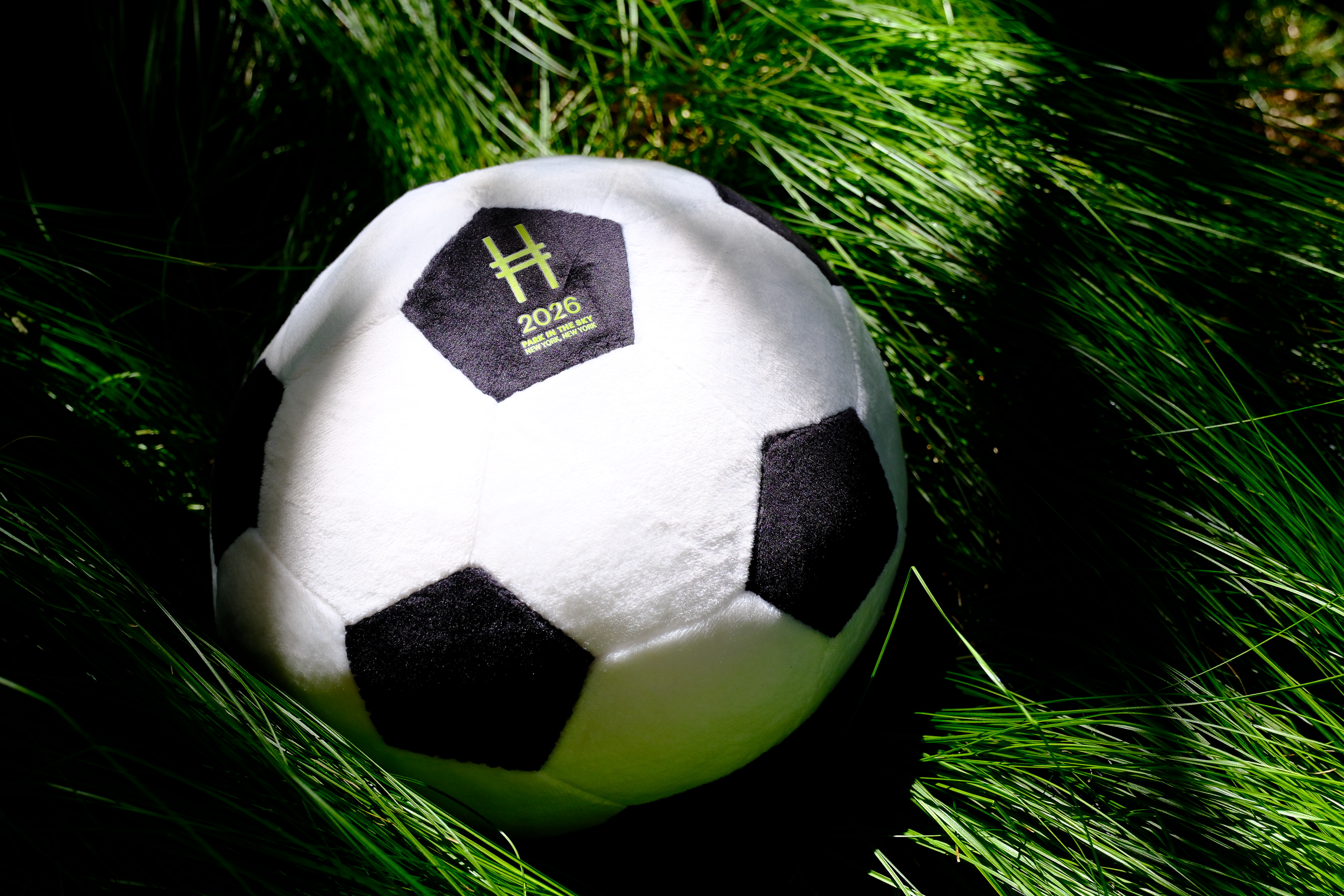 High Line Soccer Plush against grasses dappled in sunlight.
