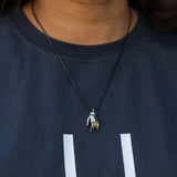 Varada mudra pendant on a woman's neck.