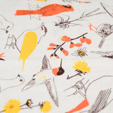 Closeup of the Claudia Pearson x High Line Washington Grassland tea towel. The flour sack cotton tea towel is covered in illustrations of birds and plants that populate the High Line in browns, yellows and oranges.