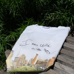 Wild in the 90s Tee folded and resting on one of the benches on the High Line.