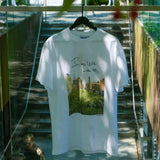 Wild in the 90s Tee hanging on the High Line's Gansevoort Staircase railing. The shirt features one of Joel Sternfeld's iconic photos of the High Line with the phrase "I was wild in the 90s" in his handwriting.