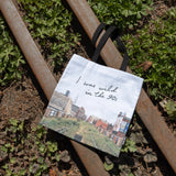 Wild in the 90s Tote, featuring one of Joel Sternfeld's iconic photos of the abandoned High Line shown against the rail tracks running along the High Line.