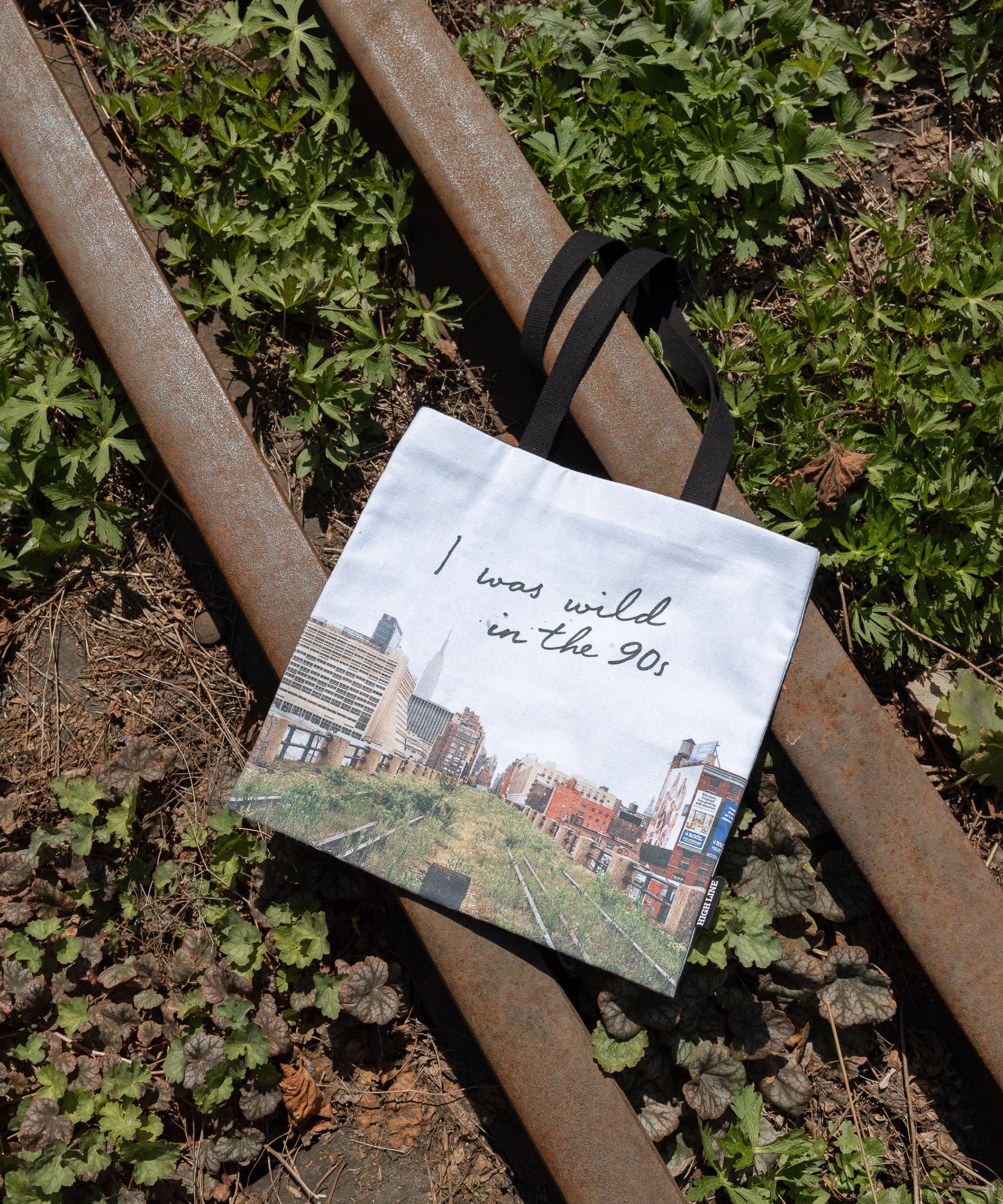 Wild in the 90s Tote, featuring one of Joel Sternfeld's iconic photos of the abandoned High Line shown against the rail tracks running along the High Line.