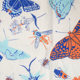 Claudia Pearson x High Line Wildflower Field tea towel, shown in detail. The flour sack cotton tea towel is covered in illustrations of butterflies, ladybugs, moths, other insects and wildflowers in blues and oranges.