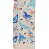 Claudia Pearson x High Line Wildflower Field tea towel, folded in sixths. The flour sack cotton tea towel is covered in illustrations of butterflies, ladybugs, moths, other insects and wildflowers in blues and oranges.