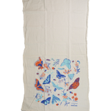 Claudia Pearson x High Line Wildflower Field tea towel, shown unfolded. The flour sack cotton tea towel is half covered in illustrations of butterflies, ladybugs, moths, other insects and wildflowers in blues and oranges.